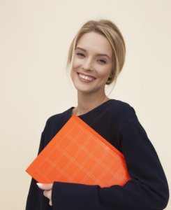 Woman smiling holding a book